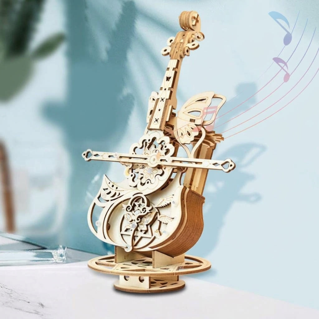 Boîte à musique violoncelle en bois vue de trois quarts, sur son socle rond