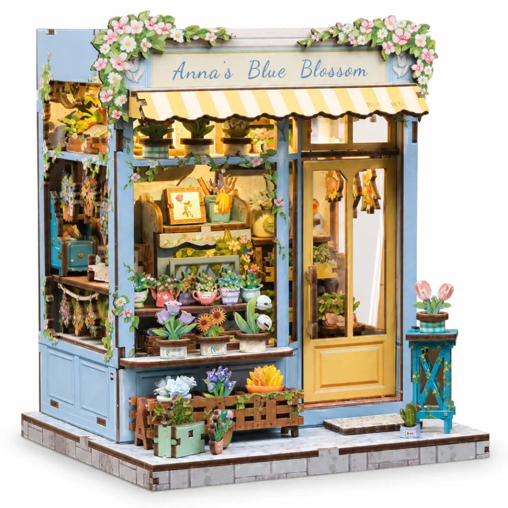 Book nook fleuriste éclairé, vu de trois quarts sur fond blanc
