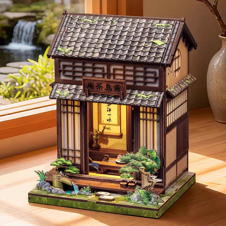 Book nook maison de thé japonaise près d'une fenêtre, cascade en arrière-plan