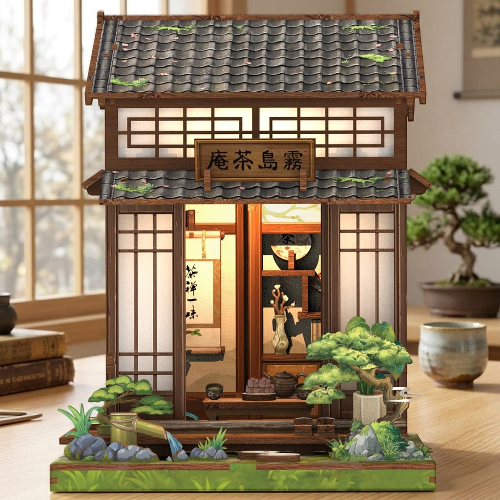 Book nook maison de thé japonaise sur un bureau à côté d'un bonsaï et d'une tasse