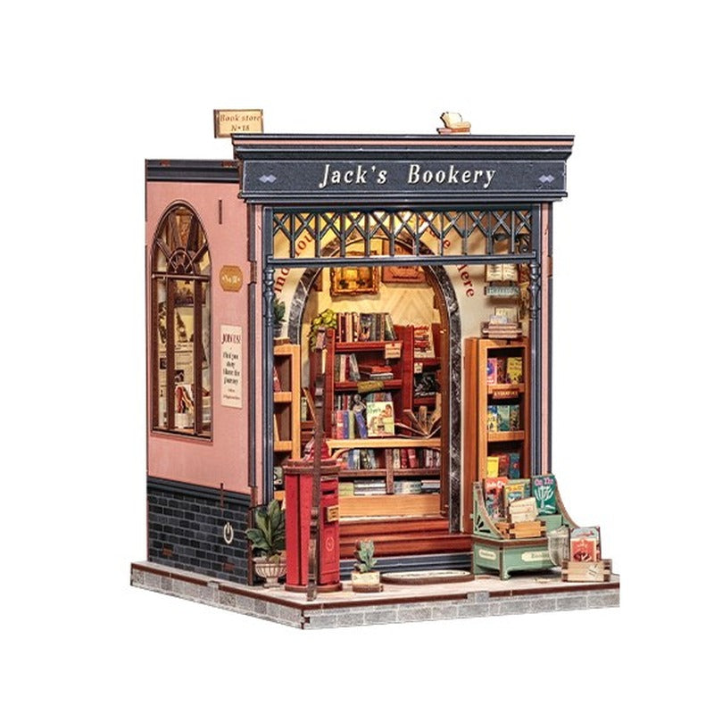Book nook librairie à façade rose en bois, vue de trois quarts sur fond blanc