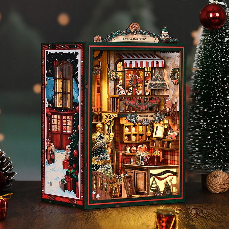 Book nook Noël boutique de cadeaux avec son panneau latéral de rue enneigée